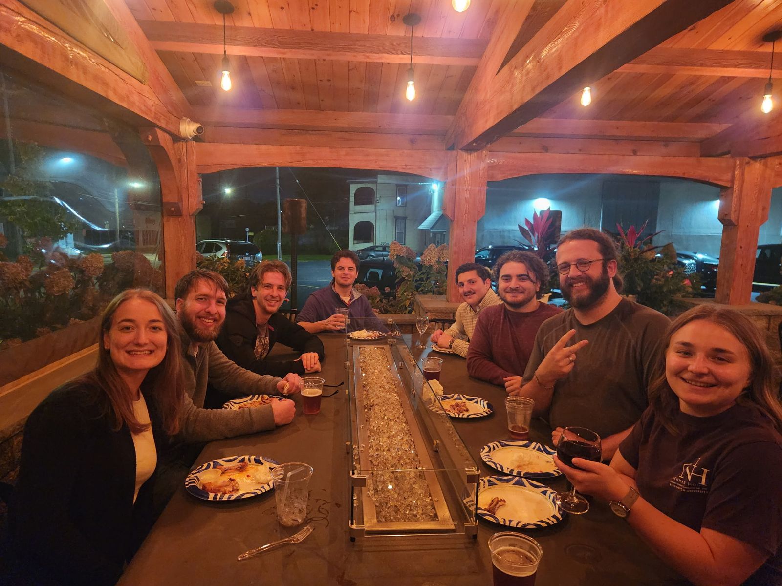 Young adults smiling around a table