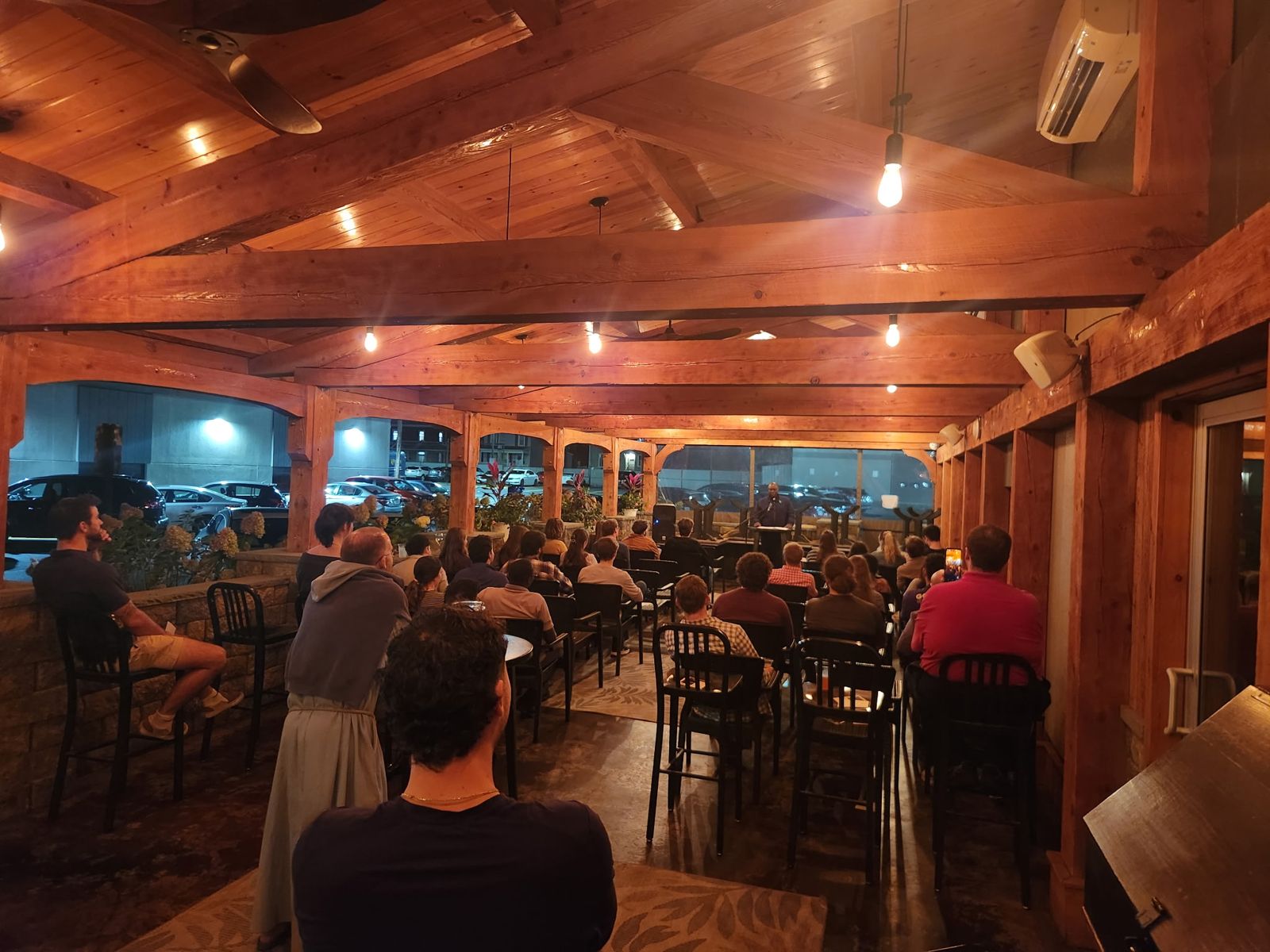 Speaker addressing a full patio